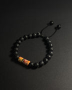 Close-up of The Barrel Bracelet featuring stacked 8mm Picasso jasper wheel beads, lava stone, and adjustable sliding knot.