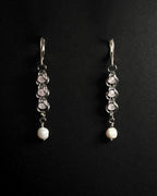 Natural Rose Quartz capture bead earrings with lever back hooks with freshwater pearl against dark background