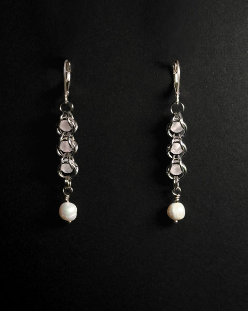 Natural Rose Quartz capture bead earrings with lever back hooks with freshwater pearl against dark background