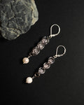 Natural Rose Quartz capture bead earrings with lever back hooks with freshwater pearl against dark background