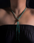 Close-up of natural Tiger Iron centre stone and turquoise beads on a handmade bolo inspired necklace.