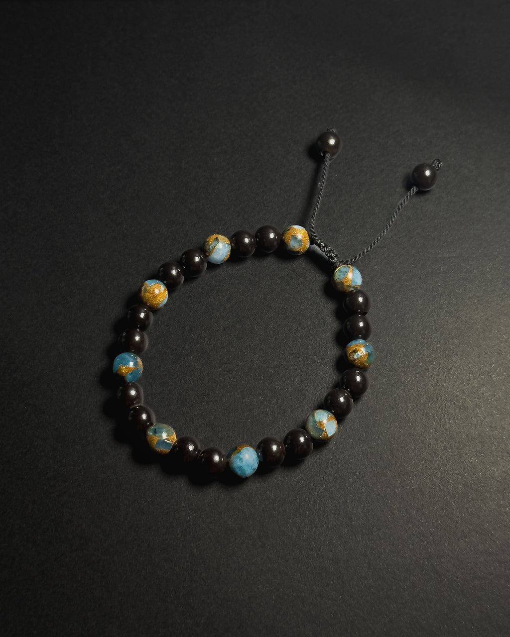Blue Lake Bracelet featuring 8mm lake blue variscite and tourmaline beads with adjustable sliding knot closure.