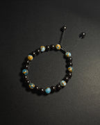 Blue Lake Bracelet featuring 8mm lake blue variscite and tourmaline beads with adjustable sliding knot closure.