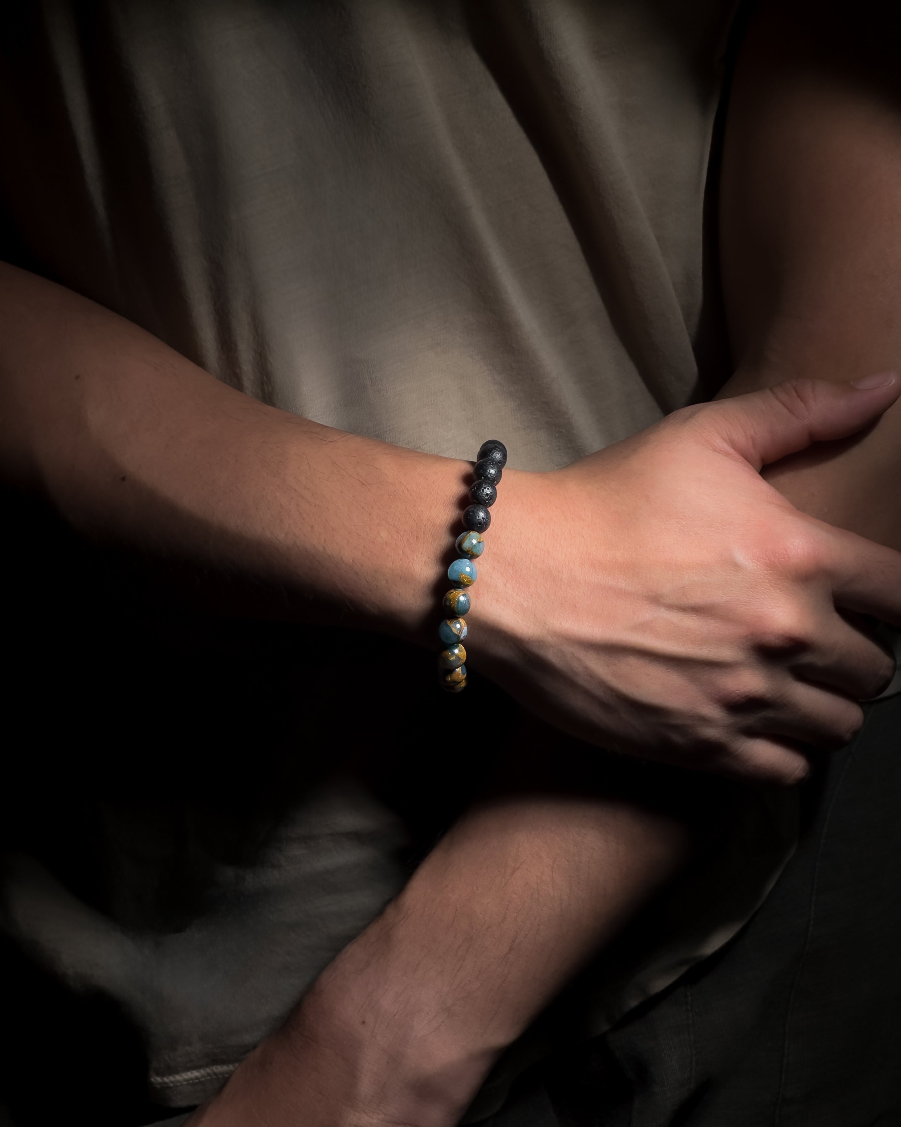 Blue Lake Bracelet featuring 8mm lake blue variscite and lava stone beads with adjustable sliding knot closure.