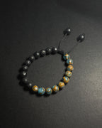 Blue Lake Bracelet featuring 8mm lake blue variscite and lava stone beads with adjustable sliding knot closure.