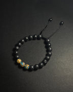 Blue Lake Bracelet featuring 8mm lake blue variscite and lava stone beads with adjustable sliding knot closure.