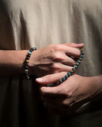 Model styling the Blue Lake Bracelet, a handmade natural stone bracelet crafted with 8mm lake blue variscite.