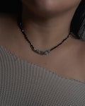 Model wearing The New Moon Necklace handcrafted with silver obsidian and grey moonstone.