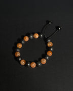 Close-up of natural 10mm sunstone and lava stone beads alternating, showing unique stone textures and variations.