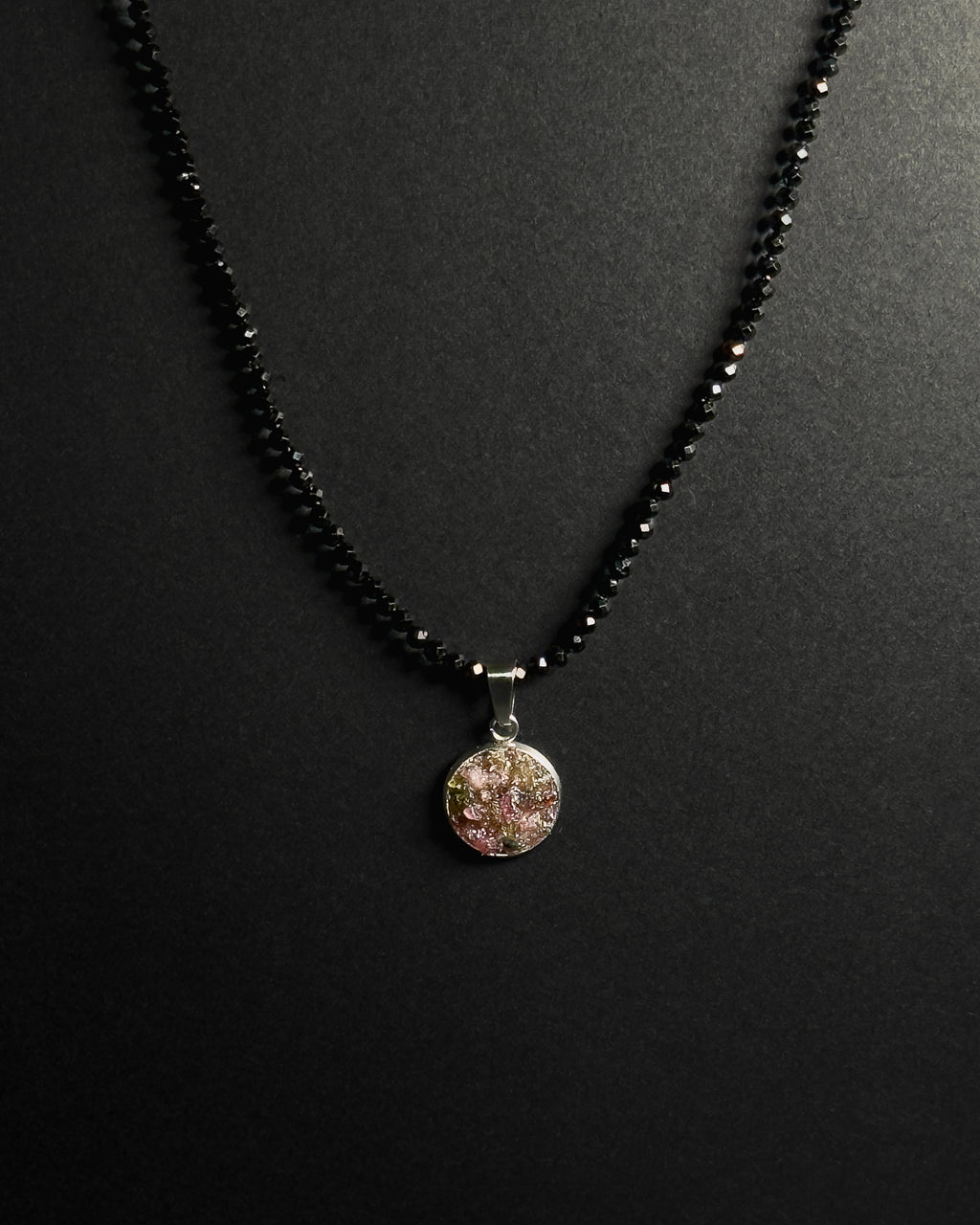 Natural spinel beaded necklace with a stainless steel pendant featuring crushed rainbow tourmaline inlay.