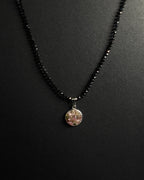 Natural spinel beaded necklace with a stainless steel pendant featuring crushed rainbow tourmaline inlay.
