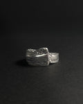 Solid stainless steel spoon ring handcrafted from vintage silverware patterns in a fixed size, displayed on a dark black background.