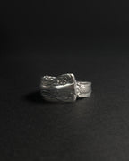 Solid stainless steel spoon ring handcrafted from vintage silverware patterns in a fixed size, displayed on a dark black background.