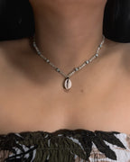 Beaded Necklace with a shell pendant worn by a person